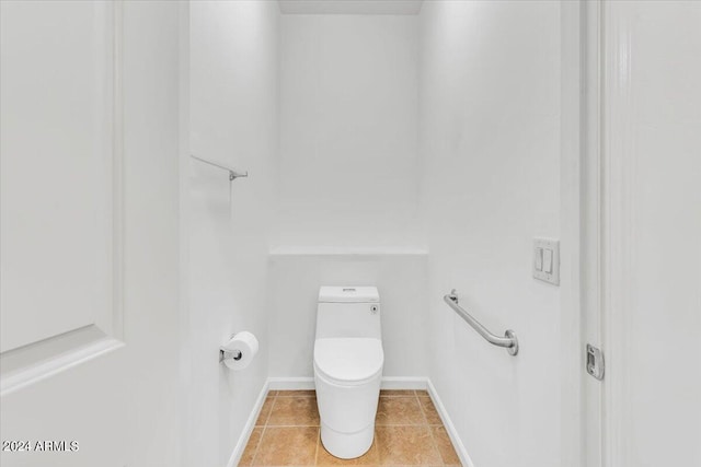 bathroom with toilet and tile patterned floors