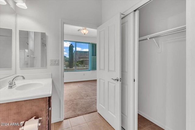 bathroom featuring tile patterned flooring and vanity