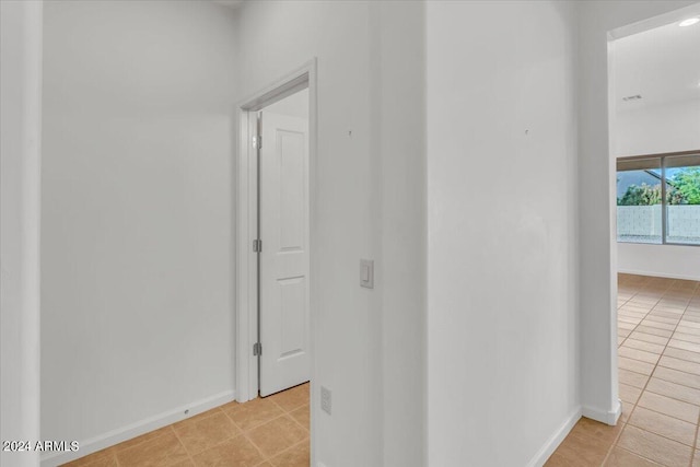 hallway with light tile patterned floors