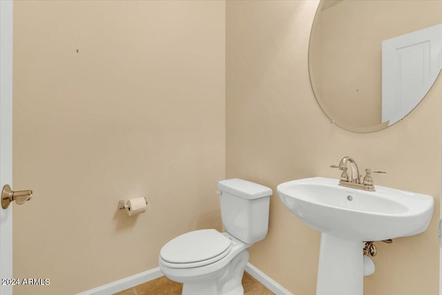 bathroom featuring tile patterned flooring and toilet