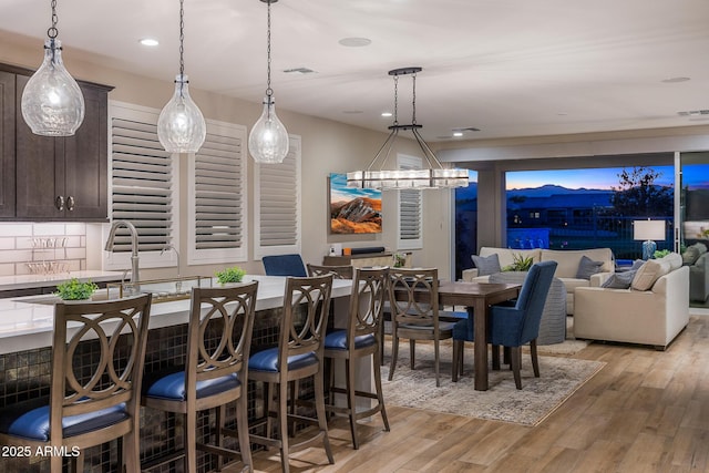 dining room featuring light wood-type flooring, visible vents, and recessed lighting