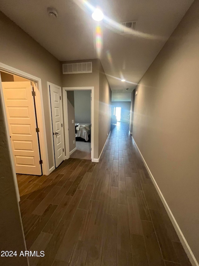 hall with dark wood-type flooring