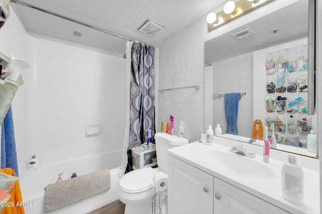 full bath featuring shower / bath combo with shower curtain, visible vents, a textured ceiling, and vanity