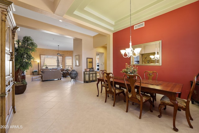 dining space featuring light tile patterned floors, baseboards, visible vents, a tray ceiling, and a chandelier