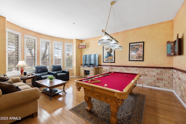 game room with hardwood / wood-style floors, billiards, a wainscoted wall, baseboards, and brick wall