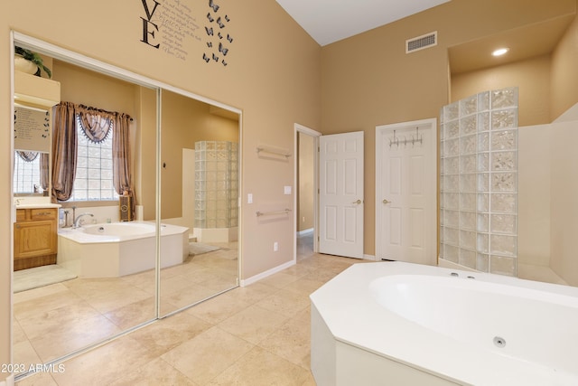 full bath with visible vents, baseboards, a walk in shower, tile patterned floors, and a jetted tub