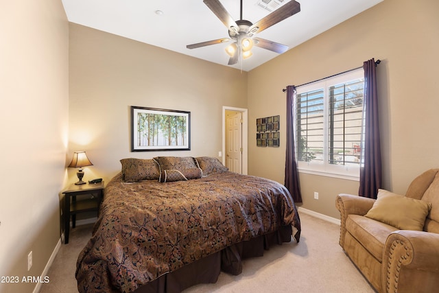 bedroom featuring a ceiling fan, light colored carpet, and baseboards