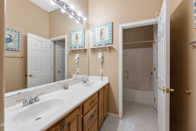 full bathroom featuring a sink, bathtub / shower combination, double vanity, and tile patterned flooring