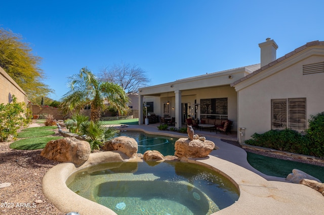 view of swimming pool featuring a patio and an in ground hot tub