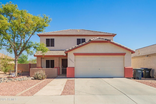 mediterranean / spanish home featuring a fenced front yard, concrete driveway, a tiled roof, and stucco siding