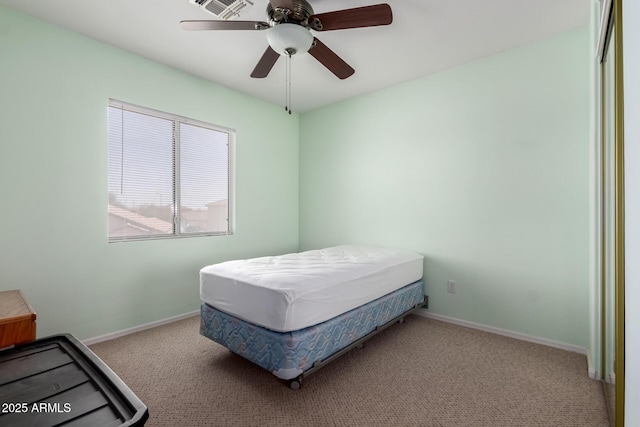 carpeted bedroom with ceiling fan and baseboards