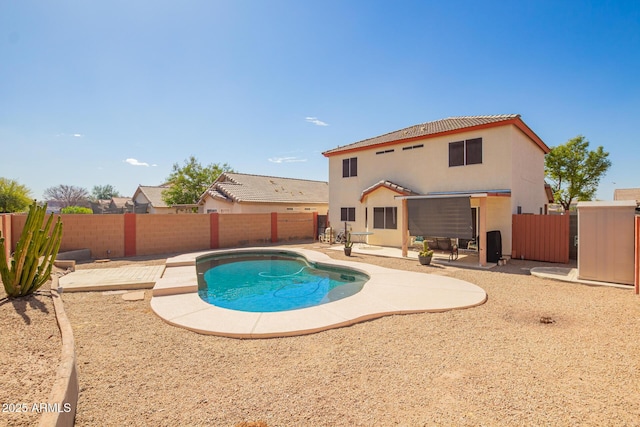 view of swimming pool featuring a patio area, a fenced backyard, and a fenced in pool