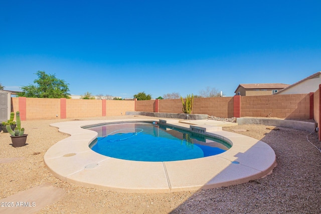 view of swimming pool featuring a fenced backyard and a fenced in pool