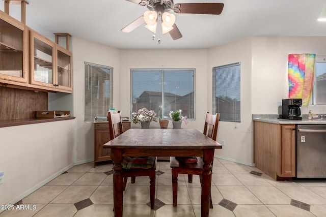 dining space with visible vents, ceiling fan, baseboards, and light tile patterned floors