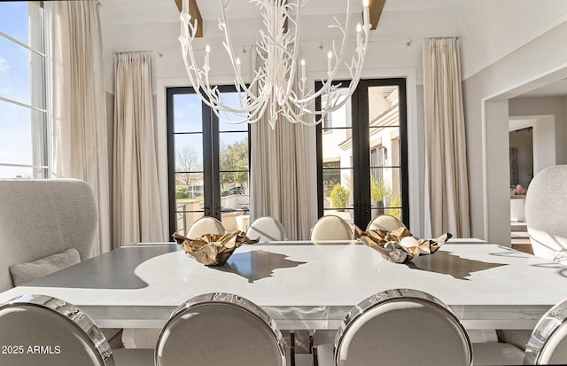 dining space featuring a notable chandelier and french doors