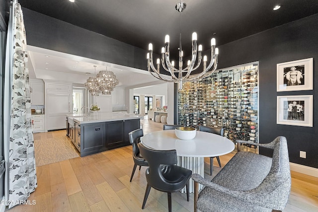 dining room featuring a notable chandelier and light wood-type flooring