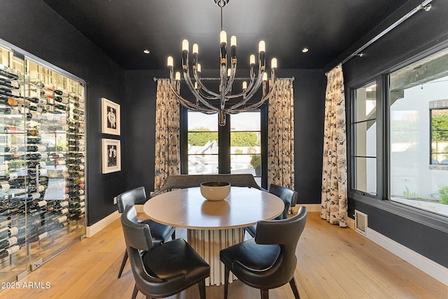 dining room with a chandelier and light wood-type flooring