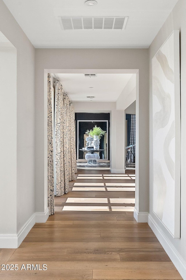 corridor featuring wood-type flooring