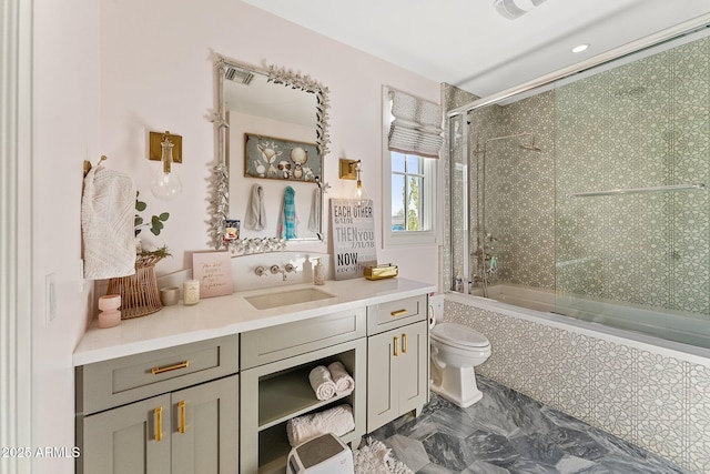 bathroom with vanity and bath / shower combo with glass door