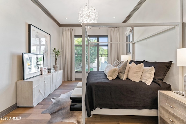 bedroom with crown molding, light hardwood / wood-style floors, and a notable chandelier