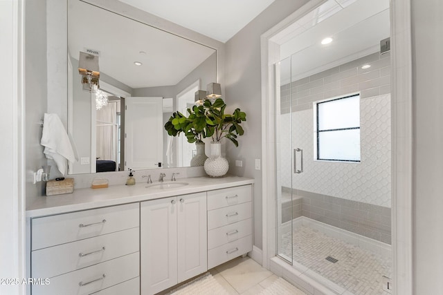 bathroom featuring vanity and a shower with door