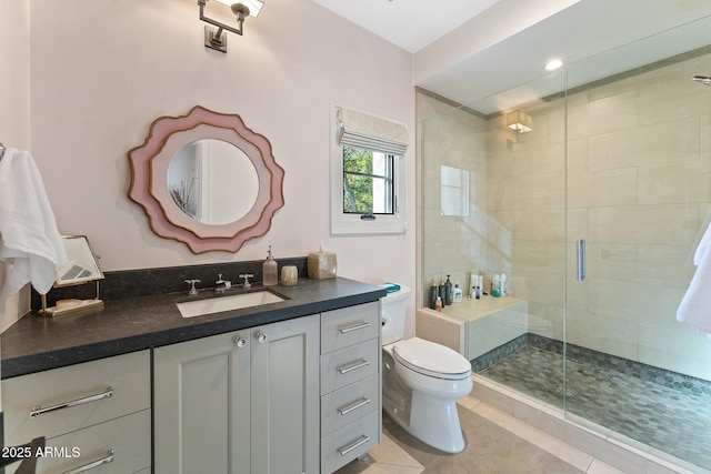 bathroom featuring walk in shower, vanity, toilet, and tile patterned flooring