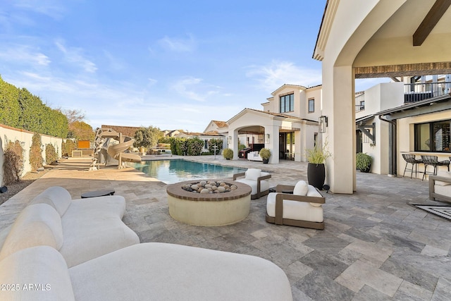 view of pool with a patio and an outdoor fire pit