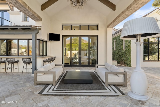 view of patio / terrace with a bar, outdoor lounge area, and french doors