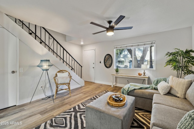 living room with light wood-type flooring and ceiling fan