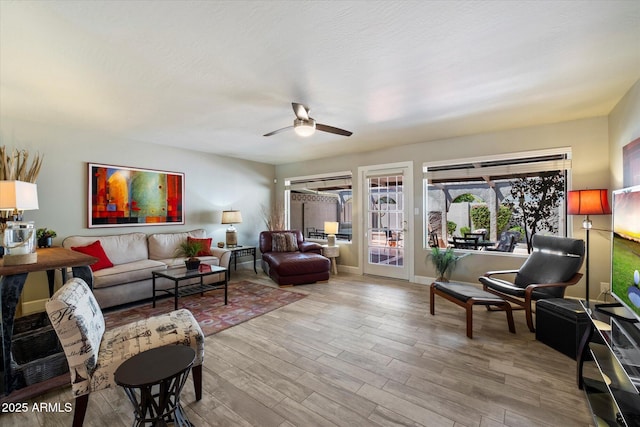 7736 E Hazelwood St, Scottsdale, AZ 85251 - living room featuring ceiling fan and light wood finished floors