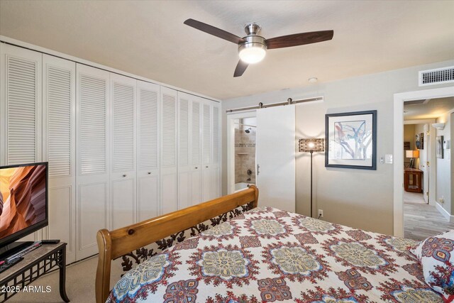 7736 E Hazelwood St, Scottsdale, AZ 85251 - bedroom featuring a ceiling fan, a closet, a barn door, and visible vents