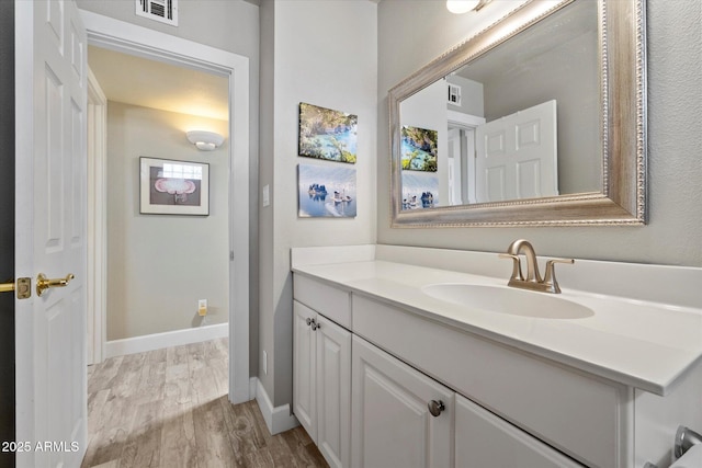 7736 E Hazelwood St, Scottsdale, AZ 85251 - bathroom with vanity, baseboards, wood finished floors, and visible vents