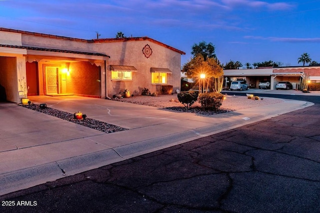 7736 E Hazelwood St, Scottsdale, AZ 85251 - mediterranean / spanish-style house featuring stucco siding and driveway
