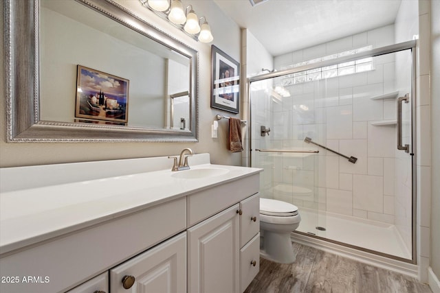 7736 E Hazelwood St, Scottsdale, AZ 85251 - bathroom featuring vanity, toilet, wood finished floors, and a stall shower