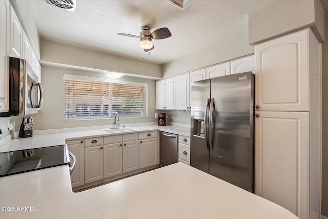 7736 E Hazelwood St, Scottsdale, AZ 85251 - kitchen with white cabinets, ceiling fan, a sink, light countertops, and stainless steel appliances