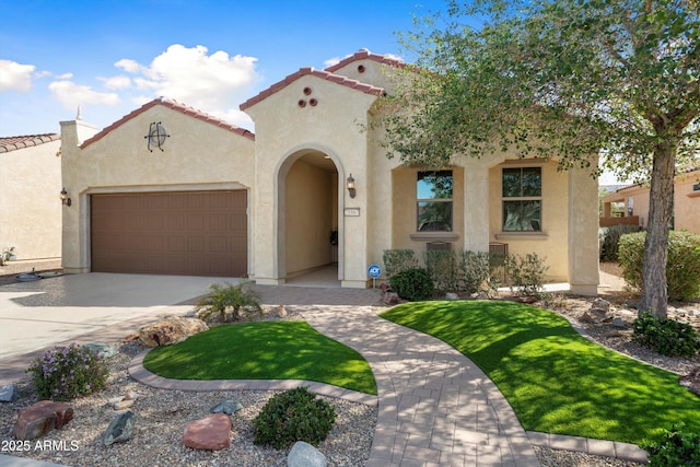 mediterranean / spanish-style home featuring a garage, a tile roof, concrete driveway, and stucco siding