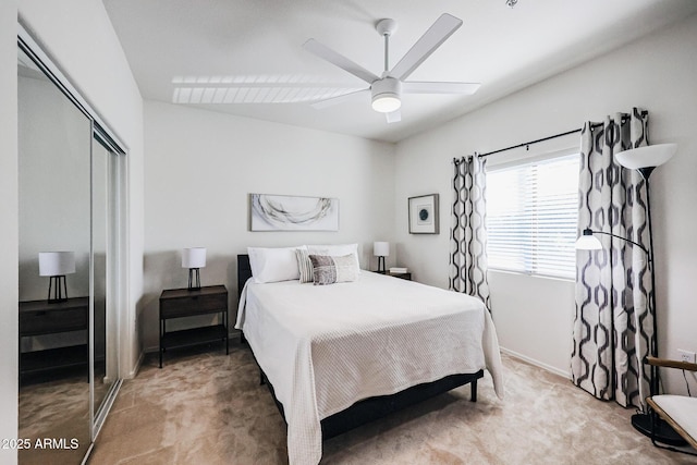 carpeted bedroom featuring ceiling fan and a closet