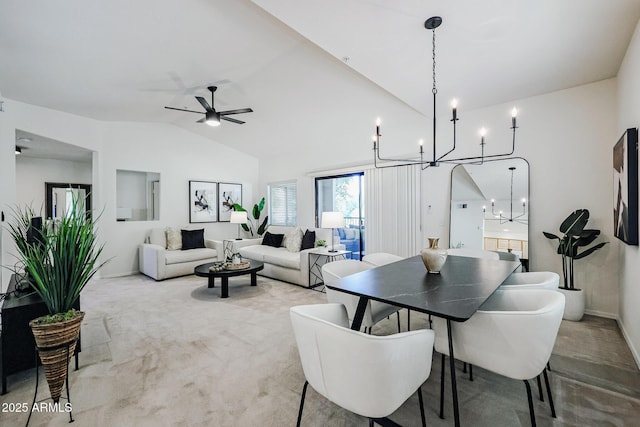 carpeted dining room with ceiling fan and lofted ceiling