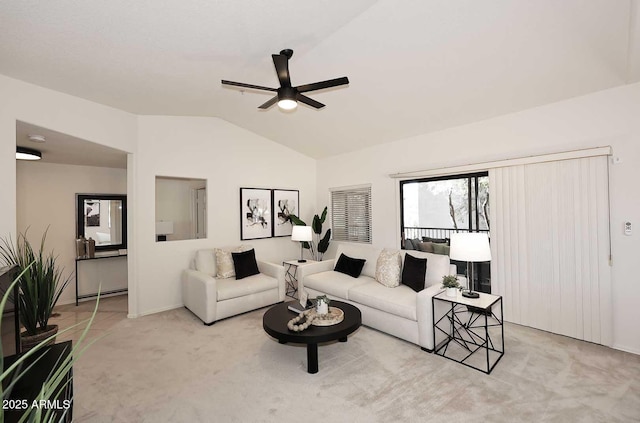 carpeted living room featuring ceiling fan and lofted ceiling