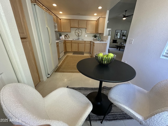 kitchen with white appliances, light brown cabinets, sink, light tile patterned flooring, and ceiling fan