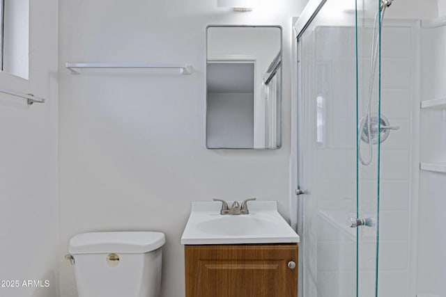 bathroom with toilet, a stall shower, and vanity