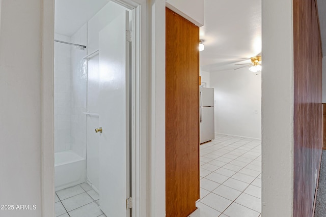 hall featuring light tile patterned flooring