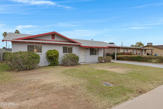 ranch-style home with a front lawn