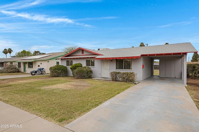 ranch-style house featuring a carport, concrete driveway, a front lawn, and roof with shingles