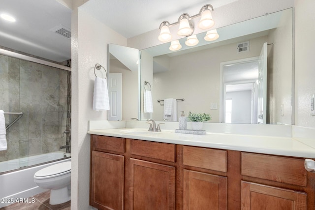 bathroom featuring toilet, vanity, enclosed tub / shower combo, and tile patterned floors