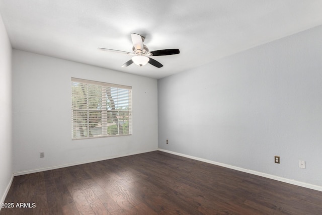 empty room with wood finished floors, a ceiling fan, and baseboards