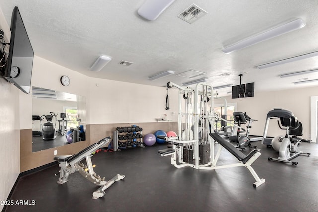 gym with a textured ceiling