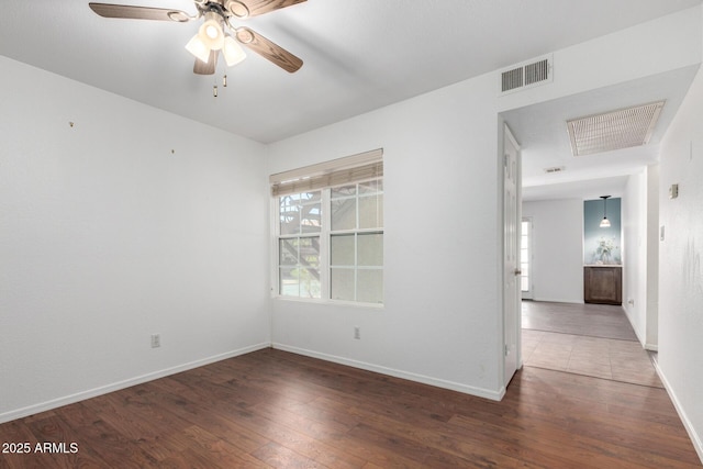 unfurnished room featuring a ceiling fan, hardwood / wood-style floors, and baseboards