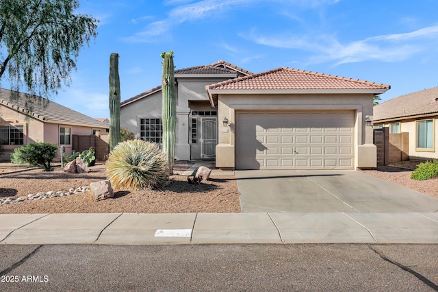 mediterranean / spanish-style house featuring a garage, stucco siding, driveway, and a tile roof