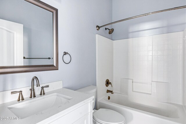 bathroom featuring vanity, bathtub / shower combination, and toilet